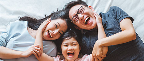 Happy, young family laying down